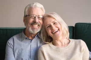 Head shot portrait of laughing elderly attractive couple